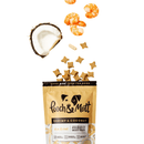 White background with an open peach coloured packet of Pooch & Mutt dog treats, treats are spilling out from the packet along with a quarter of a coconut and some shrimp. 