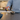 Person pouring a supplement bottle of Pooch & Mutt Salmon oil into a bowl on a kitchen counter.