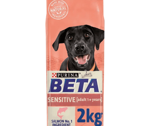 White background with a pink bag of Purina Beta Sensitive Adult Dog Food. Pictured on the bag is a black Labrador dog, text on the bag reads 'Purina Beta, Sensitive, Adult (1+ years) Salmon No.1 Ingredient.' 