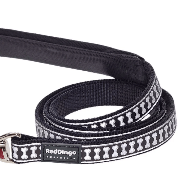 A close up of a Red Dingo Black Bones Dog Lead on a white background