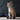 Burmese cat wearing a turquoise 'Red Dingo' cat collar with white stars on it.