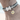 Close up of a Weimaraner Dog wearing a grey and black 'Red Dingo' dog collar with bees on it. 