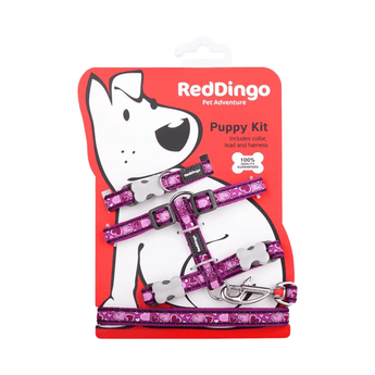 White background with a purple 'Red Dingo' puppy kit with purple hearts on it, attached to a red cardboard backing with a illustrated puppy on it.