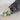 Grey adult cat playing with a brown and green Rosewood Flapperz duck cat toy with a yellow beak and feathers attached to the wings, stitched eye details.