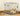 Cream coloured Pomeranian dog lying in a Rosewood Options dog crate in a corner of a room with a bowl next to it.