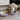 Silver tabby cat pictured eating from a shallow lilac coated stainless steel Rosewood Premium pet bowl in a kitchen environment. 