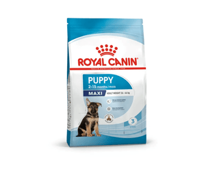 White background with a blue bag of Royal Canin Maxi Puppy. Pictured on the bag is a German Shepherd puppy , text on the bag states '2 - 15 months' and 'Maxi, Adult Weight upto 26-44kg'. 
