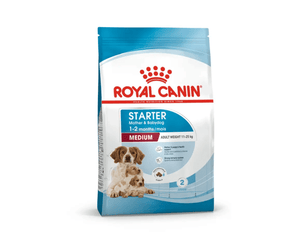 White background with a blue bag of Royal Canin Mother & Babydog. Pictured on the bag is an adult Spaniel dog and two puppies, text on the bag states '1-2months, Medium, Adult weight 11 -25kg'. 
