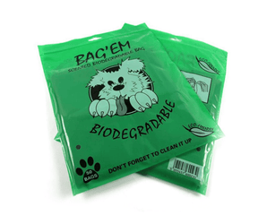 White background with two green packets of BAG'EM scented biodegradable dog waste bags, with an illustrated dog on the pack. Text below says 'Don't forget to clean it up'. 