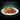 Black background with a white bowl of Sheba Fine and Fresh wet food in jelly pictured.
