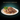 Black background with a teal bowl of Sheba Fine and Fresh wet food in gravy pictured.