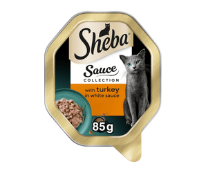 White background with a tray of Sheba Sauce Collection with Turkey in white sauce, pictured on the front is a British blue cat.