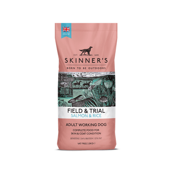 A bag of Skinner's Field & Trial Salmon & Rice dog food for adult working dogs, featuring a dusty pink packaging design with a central illustration of a hunting scene.