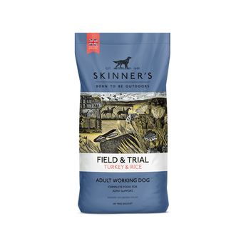 A bag of Skinner's Field & Trial Turkey & Rice dog food for adult working dogs, featuring a blue packaging design with an illustrated rural scene in the center.