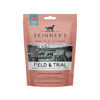 A stand-up pouch of Skinner's Field & Trial Joint & Conditioning Dog Treats, featuring a dusty rose colour with a central illustration of horses and a mountain landscape. The packaging includes a 'British Made' badge and a hanging hole at the top.