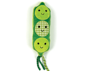 A green plush pea pod toy with three smiling faces and two dangling ribbon tails, photographed on a plain white background.