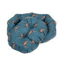 Bolster-type blue dog bed with illustrated stags pictured on a white background, the inner cushion is shown slightly out of the bed. 